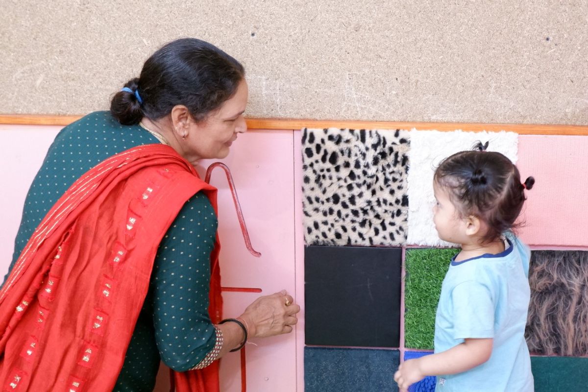 SEWA Delhi Community Childcare Learning Activity SEWA Delhi childcare worker engaging a young child in a learning activity
