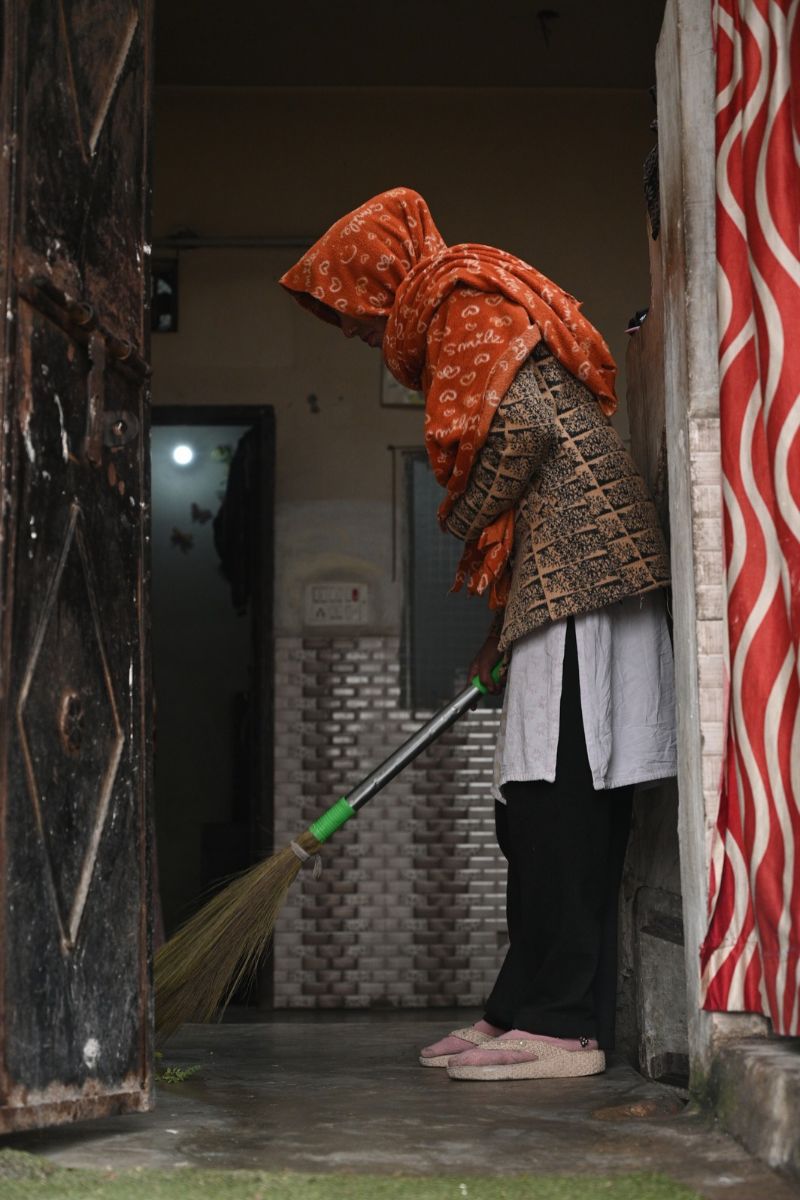 SEWA Delhi Domestic Worker Sweeping a Home Woman domestic worker sweeping a home in Delhi