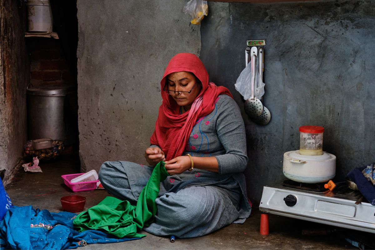 SEWA Delhi home-based woman worker stitching garments from her home