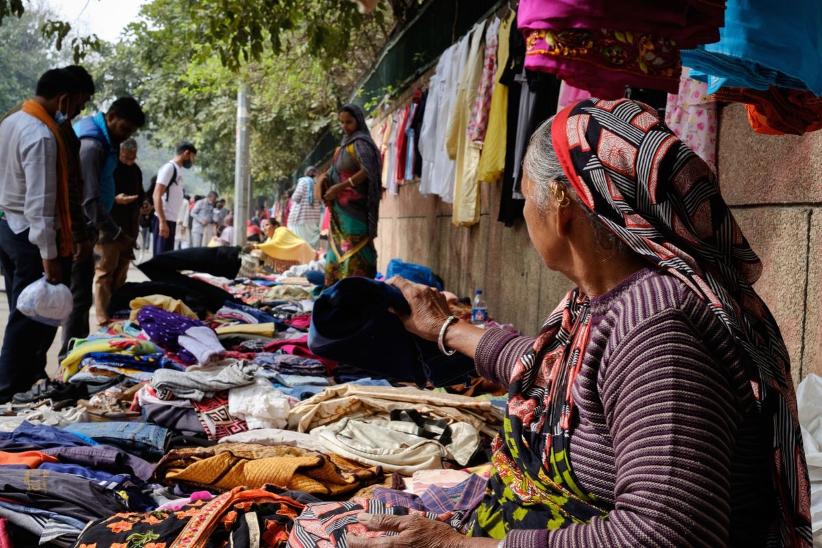 Woman street vendor selling fresh vegetables at a market in Delhi