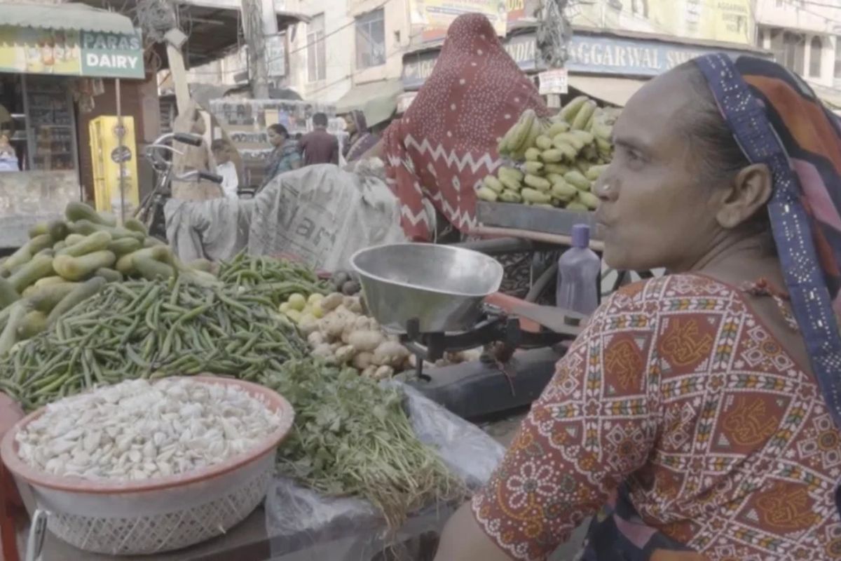 Woman street vendor selling clothing at a roadside market in Delhi