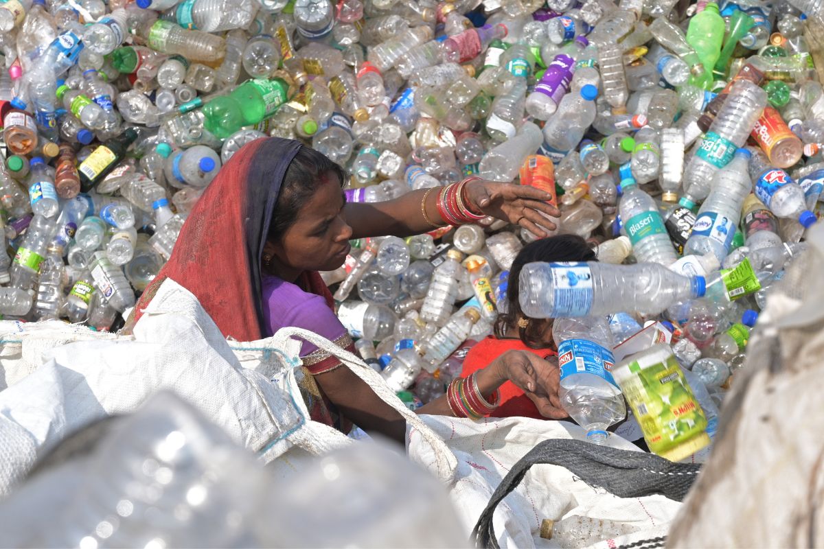 SEWA Delhi woman waste recycler sorting plastic bottles for recycling